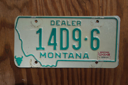 1980 Montana DEALER Silver License Plate State Shape Skull