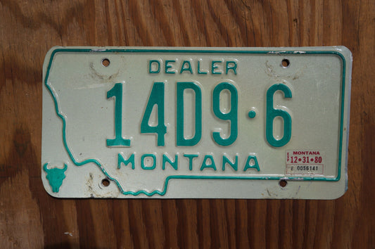 1980 Montana DEALER Silver License Plate State Shape Skull